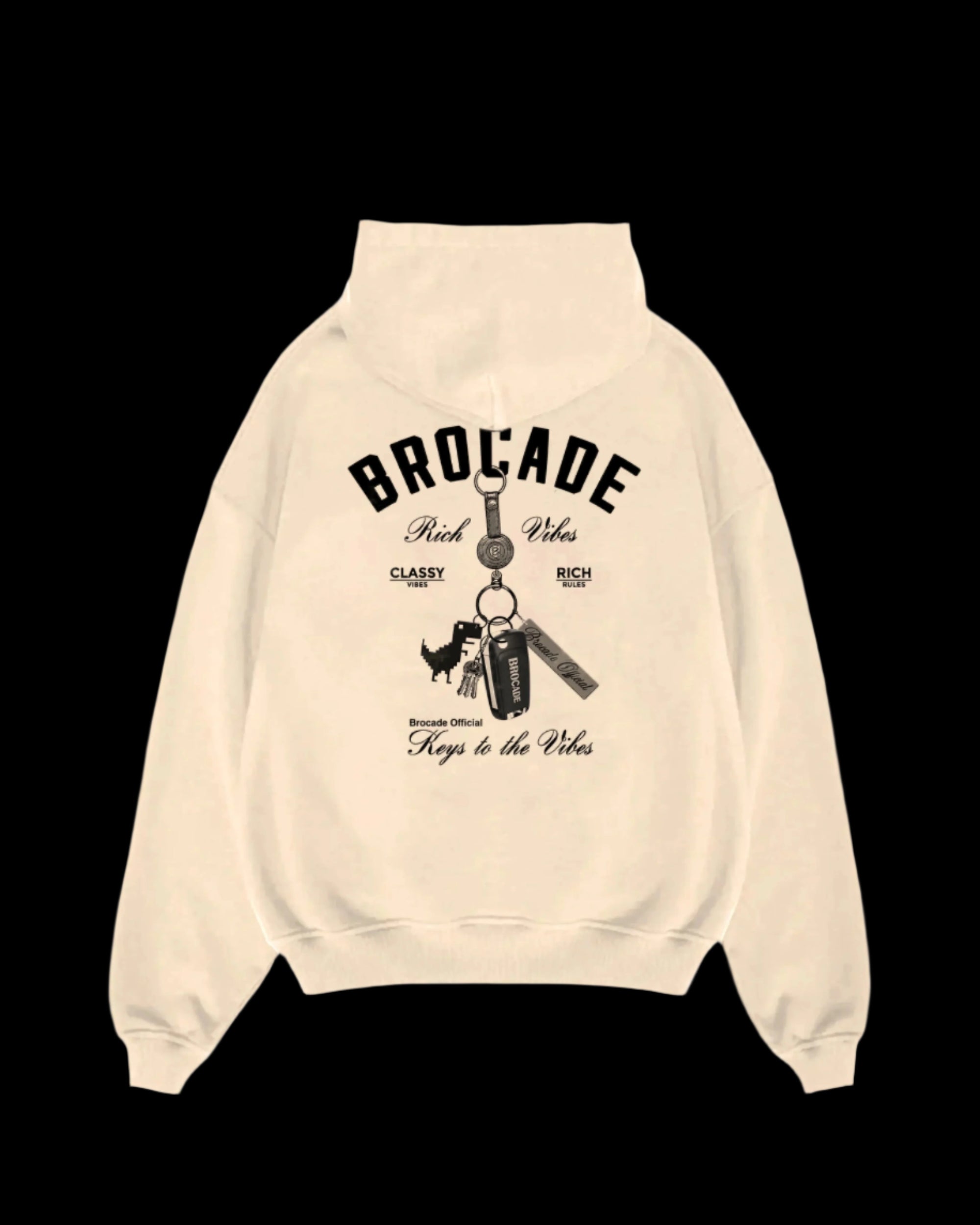 Beige hoodie with 'BROCADE' branding and graphic of a dinosaur on a keychain, along with text elements such as 'KEYS TO THE VIBES' and 'TAKE A TRIP TO THE BEACH'.